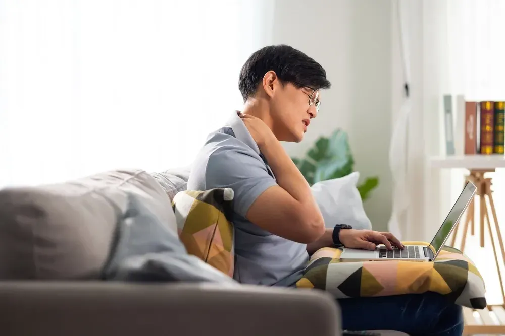 Person concerned about persistent back discomfort at Precision Chiropractic