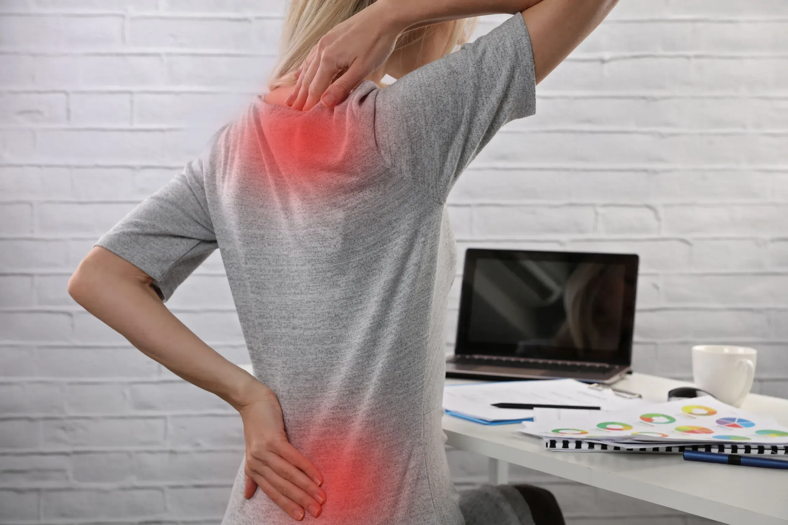 Person experiencing back pain seeking relief at Precision Chiropractic Rockford