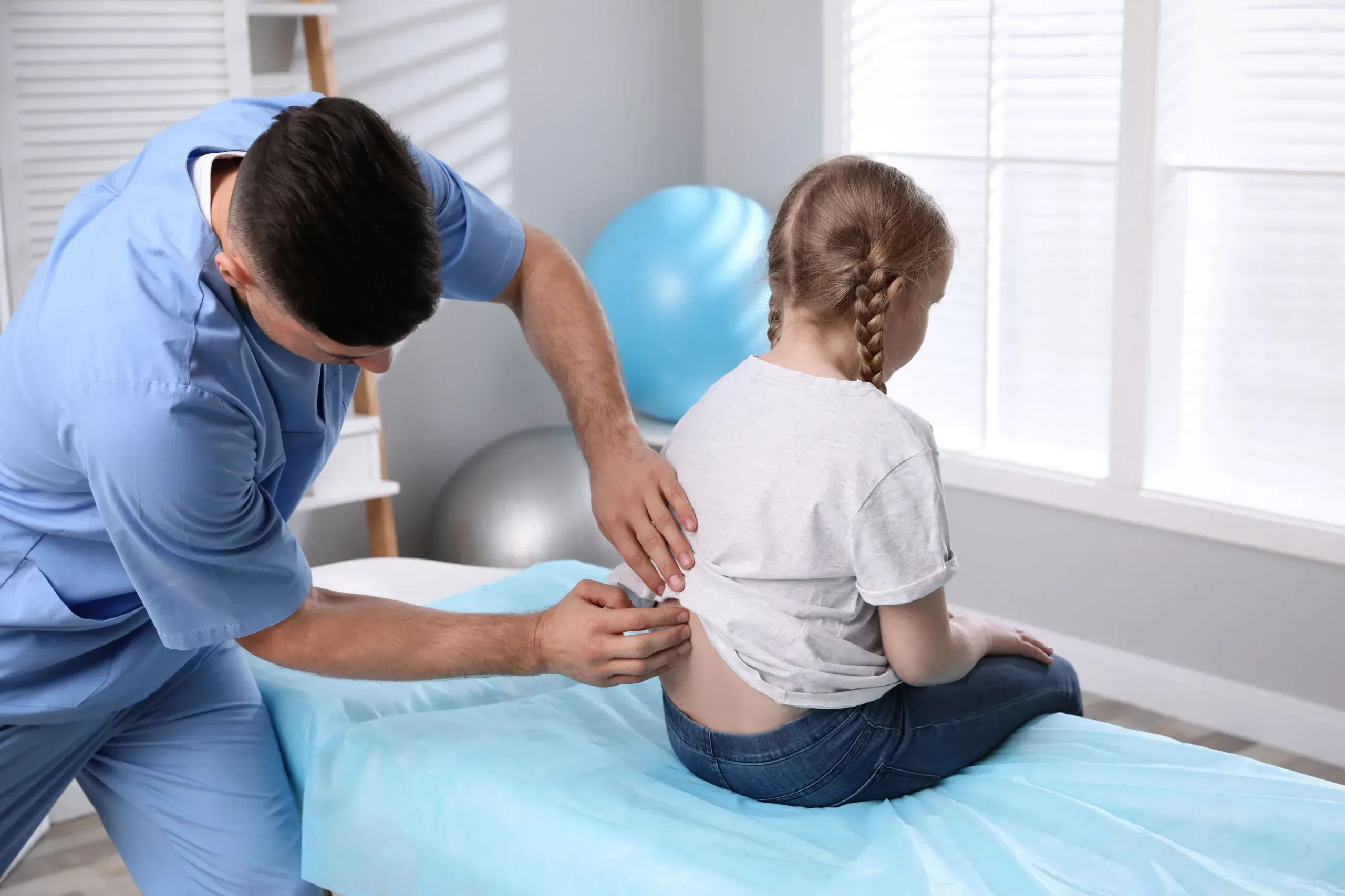 Parent consulting with Dr. Mik about pediatric chiropractic benefits at Precision Chiropractic Rockford