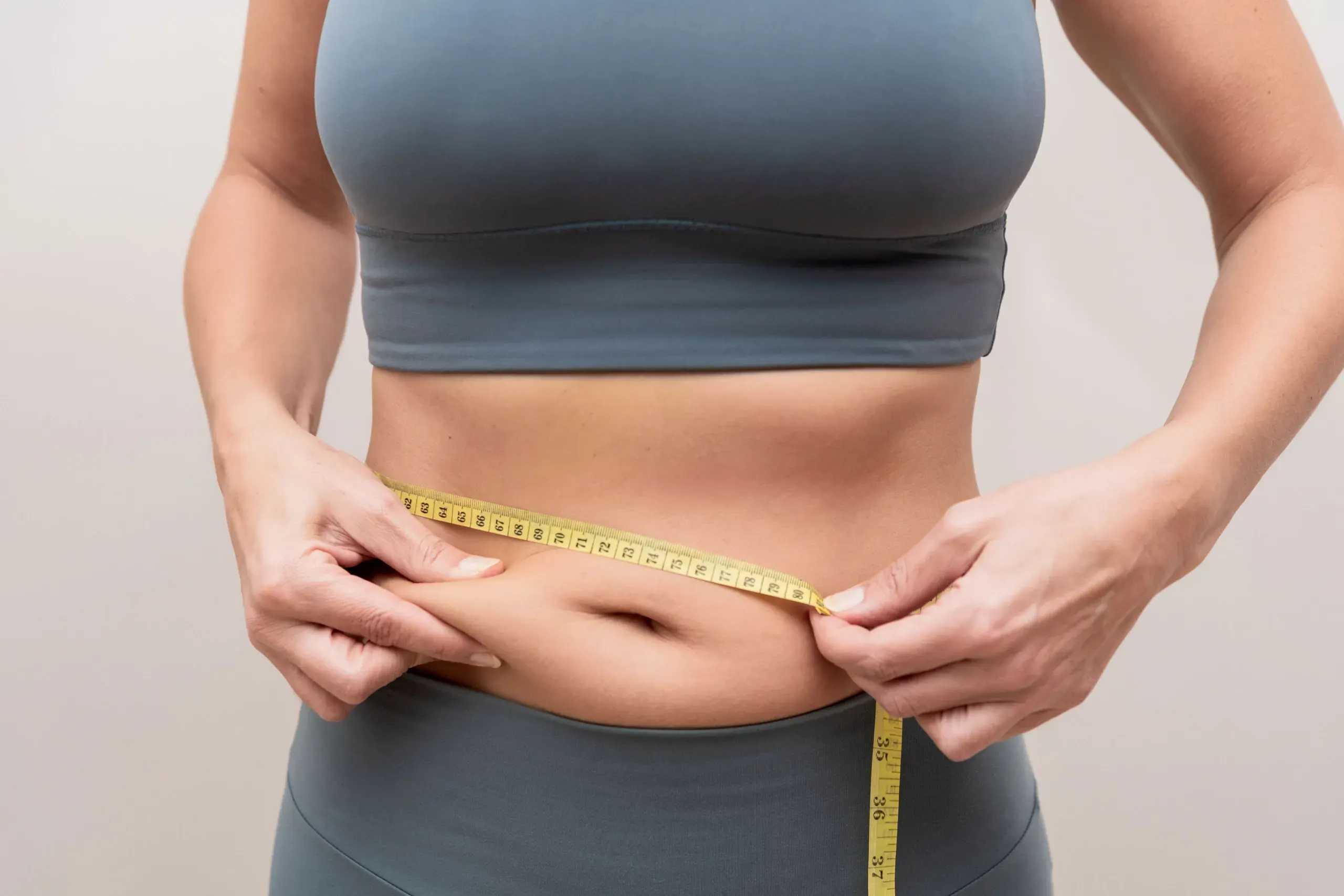 Person addressing stubborn fat concerns at Precision Chiropractic Rockford